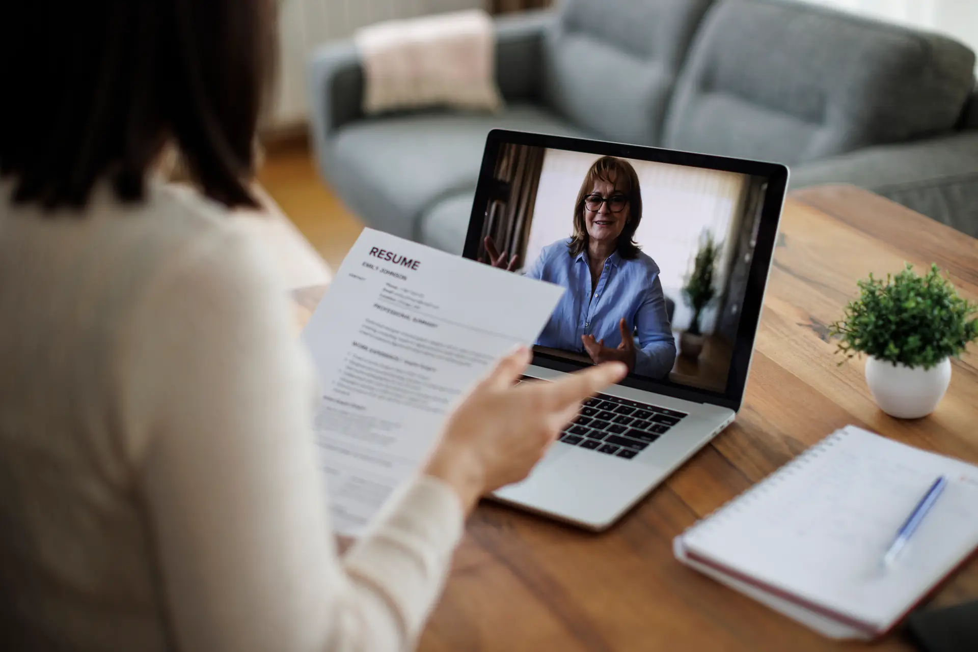 woman on zoom call with resume job search.webp
